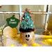 This is a whimsical Christmas elf made with a real dried gourd. This elf's name is Fraser. His face is carved into the round gourd shell. 